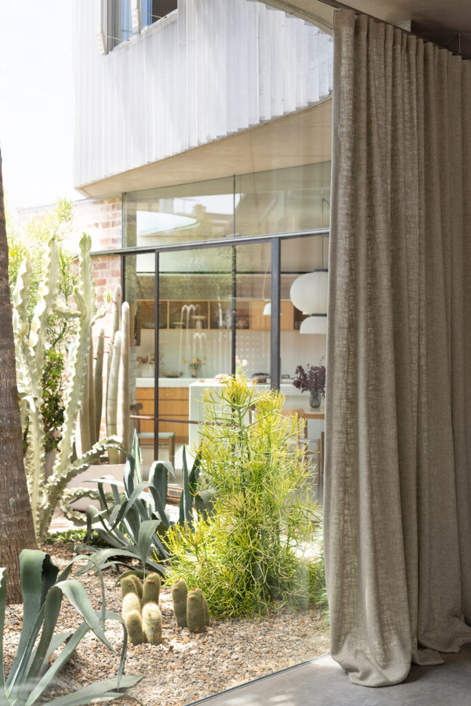 image of curtains halfway closed, showing outside area