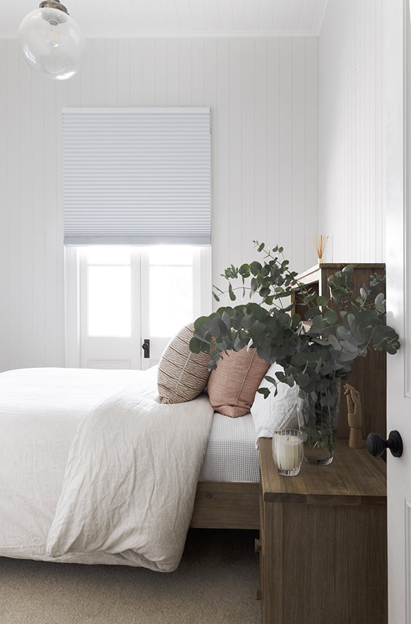 bedroom with honeycomb blinds for insulation